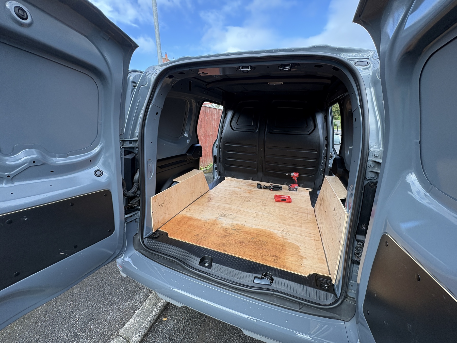 Van 001 build — plywood floor being fitted in the load area